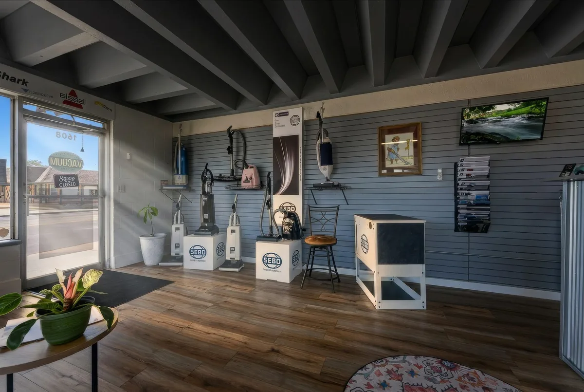 Authorized Vacuum Company showroom wall with SEBO vacuums on display